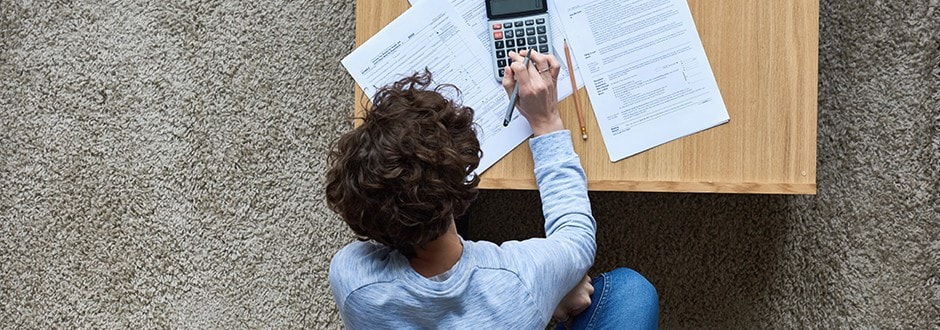 Person on couch calculating home equity loan LTV